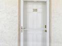 Close-up of the door to the condo, marked with the number 309, and decorative hardware at 200 1St Ave # 309, St Pete Beach, FL 33706