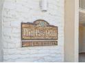 Close-up of the Point Pass-A-Gille sign, with a wood and white brick design at 200 1St Ave # 309, St Pete Beach, FL 33706