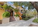 A condo's exterior shows a private entry with lush landscaping, colorful tiles, and beautiful curb appeal at 200 4Th S Ave # 220, St Petersburg, FL 33701