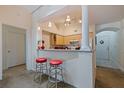 View of kitchen bar with red stools, and modern appliances at 200 4Th S Ave # 220, St Petersburg, FL 33701
