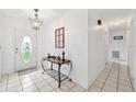 Welcoming entryway with tiled floors, chandelier, and decorative table, offering a bright introduction at 2013 Capri Rd, Valrico, FL 33594