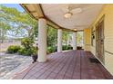 Inviting front porch with tiled flooring, ceiling fans and sturdy columns, perfect for relaxing at 202 39Th S Ave, St Petersburg, FL 33705