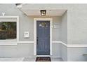 Close-up of front door showcasing architectural details, a modern light fixture, and welcoming entrance at 2230 Melrose S Ave, St Petersburg, FL 33712