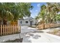 Well-maintained home with a fenced yard and tropical landscaping, showcasing curb appeal at 2230 Melrose S Ave, St Petersburg, FL 33712
