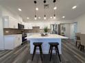 Stunning kitchen featuring white cabinetry, stainless appliances, and central island with stool seating at 2254 66Th S Ave, St Petersburg, FL 33712