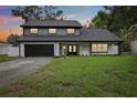 Inviting two-story home with a lush green lawn and modern exterior lighting at 226 Willowick Ave, Temple Terrace, FL 33617