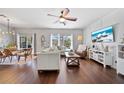 Bright living room with hardwood floors, comfortable seating, and access to the outdoor area at 2829 Maple Brook Loop, Lutz, FL 33558