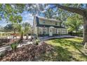 Two-story home with lush greenery and a charming front yard, perfect for relaxation and curb appeal at 301 81St Ne Ave, St Petersburg, FL 33702