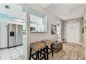 Open entryway into the kitchen, featuring wood floors and decorative elements at 3520 51St W Ave, Bradenton, FL 34210
