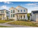 Stunning two-story home showcasing a white exterior, well-maintained lawn, and inviting front porch area at 5120 3Rd N Ave, St Petersburg, FL 33710