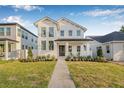 Charming two-story home with a modern white facade, lush green lawn, and a welcoming front porch at 5120 3Rd N Ave, St Petersburg, FL 33710