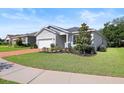 Beautiful single-story home boasts a well-kept lawn and lovely landscaping around the property at 520 Valri Park Dr, Valrico, FL 33594