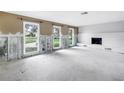 Bright living room with large windows, fireplace, and ample space for customization at 5215 Denver Ne St, St Petersburg, FL 33703