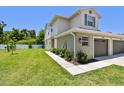 A townhouse featuring a well-maintained lawn and landscaping, showcasing curb appeal and outdoor space at 5270 Neil Dr, St Petersburg, FL 33714