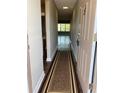 Entryway hallway showcasing a decorative rug, neutral walls and views to the living room at 5530 80Th N St # A306, St Petersburg, FL 33709