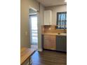 Bright kitchen featuring butcher block countertops, stainless steel sink, and modern grey and wood cabinets at 5530 80Th N St # A306, St Petersburg, FL 33709