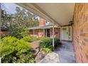Charming brick home with a covered entryway, complemented by lush landscaping for a welcoming curb appeal at 5901 3Rd S St, St Petersburg, FL 33705