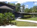 Unique architectural design with mature landscaping enhancing the property's charm at 6160 Fitzgerald Road, Odessa, FL 33556
