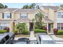 Exterior shot of inviting townhouses featuring covered entries and well-manicured greenery at 6249 Osprey Lake Cir, Riverview, FL 33578