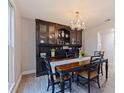 Dining room with wood floors, traditional-style furniture, chandelier, and decorative hutch at 768 Pinellas Point S Dr, St Petersburg, FL 33705