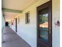 Exterior hallway with doors to units and view of palms in the distance at 801 83Rd N Ave # 209, St Petersburg, FL 33702