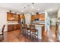 Spacious kitchen with stainless steel appliances, granite countertops, and a breakfast bar, ideal for entertaining at 8296 Olive Brook Dr, Wesley Chapel, FL 33545