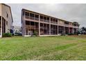 Expansive backyard view showcasing the well-maintained lawn and screened-in patios of the townhome community at 9484 Tara Cay Ct # 8, Seminole, FL 33776