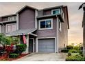 Charming two-story townhome with an attached garage and well-maintained landscaping. American flag present at 9484 Tara Cay Ct # 8, Seminole, FL 33776