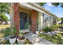 Inviting front entrance of a home with brick pillars, decorative plants, and a welcome mat at 1013 N Bask Dr, Tampa, FL 33603