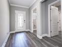 Bright foyer featuring wood flooring and a decorative front door at 10517 Crestview Heights Ave, Thonotosassa, FL 33592