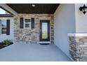 Inviting front entrance with stone accents and decorative glass door at 10517 Crestview Heights Ave, Thonotosassa, FL 33592