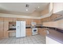 Spacious kitchen featuring ample cabinetry, stainless steel appliances, and tile flooring at 1126 Haley Ln, Dunedin, FL 34698