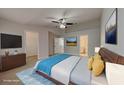 Spacious main bedroom with a large bed, ceiling fan, ensuite bath and closet at 13640 Forest Lake Dr, Largo, FL 33771