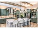 Spacious modern kitchen featuring wooden beams, a large island, and stainless steel appliances at 13726 Heartwood Way, Parrish, FL 34219