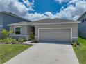 A single Gathering home has a grey shingle roof, stone accents, and well-kept lawn at 152 Bright Ibis Ave, Apollo Beach, FL 33572