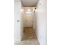 Bright hallway with tile flooring leading to the front door at 1556 Lynda Ln, Dunedin, FL 34698