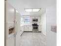Kitchen featuring white cabinetry and stainless steel appliances at 1556 Lynda Ln, Dunedin, FL 34698