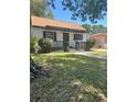 Inviting single-story home featuring a covered front porch and mature trees at 1675 13Th S Ave, St Petersburg, FL 33712