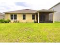 Spacious backyard featuring a screened lanai, lush green grass, and ample space for outdoor enjoyment at 18292 Hunters Meadow Walk, Land O Lakes, FL 34638