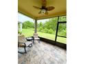 Relaxing screened lanai with comfortable seating and a ceiling fan, perfect for enjoying the outdoors at 18292 Hunters Meadow Walk, Land O Lakes, FL 34638
