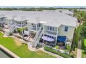 Back of townhome offering open-air decks and outdoor lounging areas with manicured yard and walkways at 219 Pompano Se Dr # C, St Petersburg, FL 33705