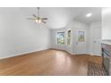 Bright living room featuring hardwood floors, a ceiling fan, and a decorative front door at 2313 Palm Ave, Seffner, FL 33584