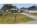Well-maintained home with a carport, complemented by a green lawn and blue skies at 2830 Anthony St, Tampa, FL 33619