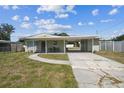 Quaint single-Gathering house featuring a covered carport and front patio seating area at 2830 Anthony St, Tampa, FL 33619