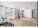 Bright living room featuring tiled floor, large window, and cozy seating area at 3348 Clydesdale Dr, Holiday, FL 34691