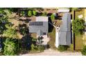 Stunning aerial view of property showcasing home, additional structure, and solar panels at 39252 Kimberly Ave, Zephyrhills, FL 33540