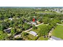 Panoramic aerial shot with property marker showcasing the home's location within a verdant landscape at 39252 Kimberly Ave, Zephyrhills, FL 33540