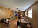 Cozy living room with paneled walls, a ceiling fan, a comfortable couch, and natural light at 4419 Atwood Dr, Tampa, FL 33610