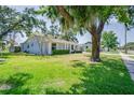 Lovely single-Gathering home with mature tree, lush green lawn, and blue exterior at 4700 Chancellor Ne St, St Petersburg, FL 33703