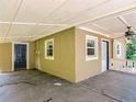 Covered carport with a ceiling fan providing convenient parking and access to the home's entrance at 473 Forest Ave, Brooksville, FL 34601